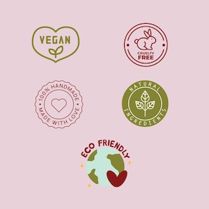 May include: Five circular and heart-shaped icons featuring text and graphics: a green heart labeled VEGAN, a red rabbit icon labeled CRUELTY FREE, a red seal stating 100% HANDMADE MADE WITH LOVE, a green circle labeled NATURAL INGREDIENTS, and an ECO FRIENDLY globe.