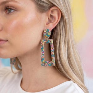 May include: A set of three ceramic mugs with a speckled, matte finish. The mugs are in shades of cream, light gray, and dark gray. Each mug has a simple, minimalist design, perfect for coffee or tea.