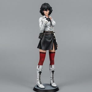May include: A detailed figurine of a character with short black hair, wearing a white jacket, black skirt, and white boots. The figure has red stockings and a small black bag. The figurine is standing on a black circular base.