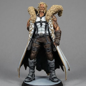 May include: A detailed figurine of a male character with blonde hair and a stern expression. He wears a white coat with gold trim, brown trousers, and black boots. The figure has a fur collar and intricate tattoos on his arm.