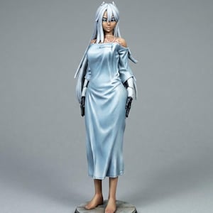May include: A figurine of a woman with long white hair and pale skin, wearing a light blue dress. The figure has black gloves and is standing on a circular base. The dress has an off-the-shoulder design.