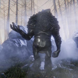 May include: A dark, textured statue of a creature with a large head and outstretched arm. The statue is set in a misty forest with tall, bare trees and rocks.