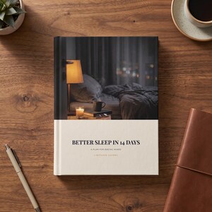 May include: A hardcover book titled Better Sleep in 14 Days: A Plan for Racing Minds by Limitless Guides. The cover features a photograph of a dimly lit bedroom with a bedside lamp, a candle, and a mug on a nightstand next to a bed.
