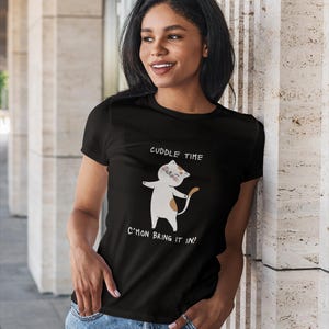 May include: Black t-shirt with a white cartoon cat and the text "Cuddle Time C'mon Bring It In!"
