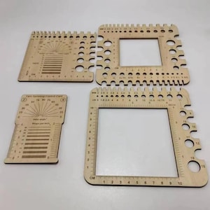 May include: Four light-colored wooden tools for fiber arts, including two square frames with various circular cutouts and measurement markings, and two rectangular cards featuring twist angle guides and wraps per inch scales.