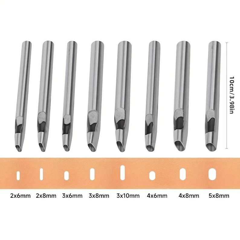 May include: A set of eight silver-colored leather hole punches with various sizes, displayed above a tan leather strip with corresponding punched holes. The punches are approximately 3.98 inches (10cm) in height. Sizes are labeled in millimeters.