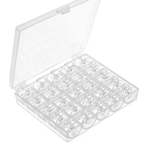 May include: A clear plastic sewing bobbin storage box with a hinged lid. The box is filled with clear bobbins, each neatly organized in individual compartments. The box is open, displaying the contents.