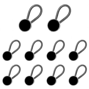 May include: A collection of nine black button extenders with silver-colored coiled springs. These extenders are designed to add extra room to pants or skirts. The black buttons are round and have a smooth finish.
