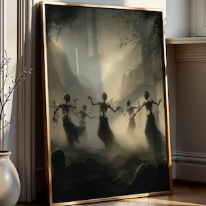 May include: A framed art print featuring a dark, atmospheric scene of skeletal figures dancing in a misty forest. The artwork has a gold frame and is leaning against a wall. The color palette is primarily dark with hints of light.