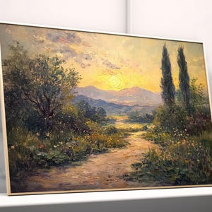 May include: Framed landscape oil painting depicting a sunset over a valley with a dirt path. The artwork features a warm colour palette with a golden sun, mountains, and trees. A potted plant sits to the right.