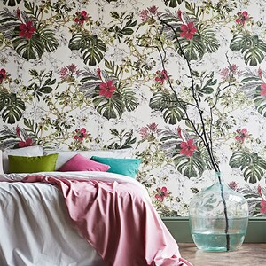 Tropical leaves botanical wallpaper behind bed