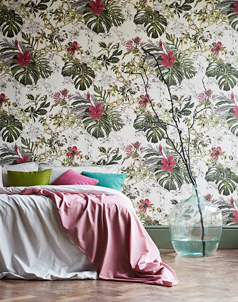 Tropical leaves botanical wallpaper behind bed