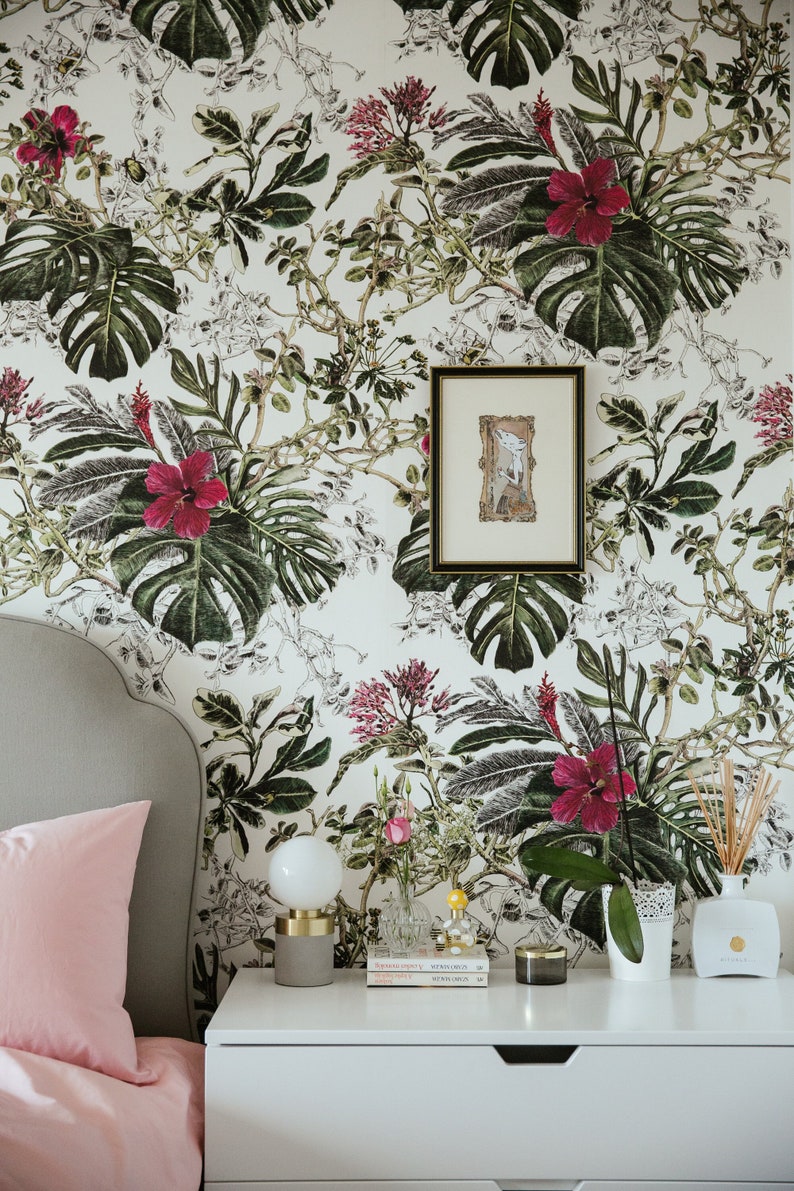 Tropical leaves botanical wallpaper behind bed