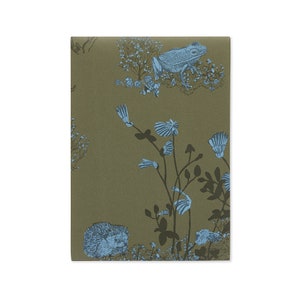 May include: A green background with a blue frog, a hedgehog, and blue flowers. The frog is sitting on a branch with leaves. The hedgehog is curled up on the ground. The flowers are blooming in the background.