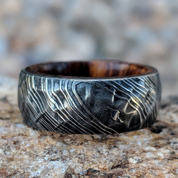 Damascus Steel Wedding Band With Ironwood Sleeve And Hammered Finish - DS-BLK-8HR-BHB-IronWoodSleeve