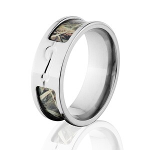 May include: A silver ring with a camouflage pattern inlay. The ring is made of titanium and has a polished finish.