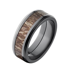 May include: A black ceramic wedding band with a brown wood inlay. The band has a beveled edge and a polished finish.