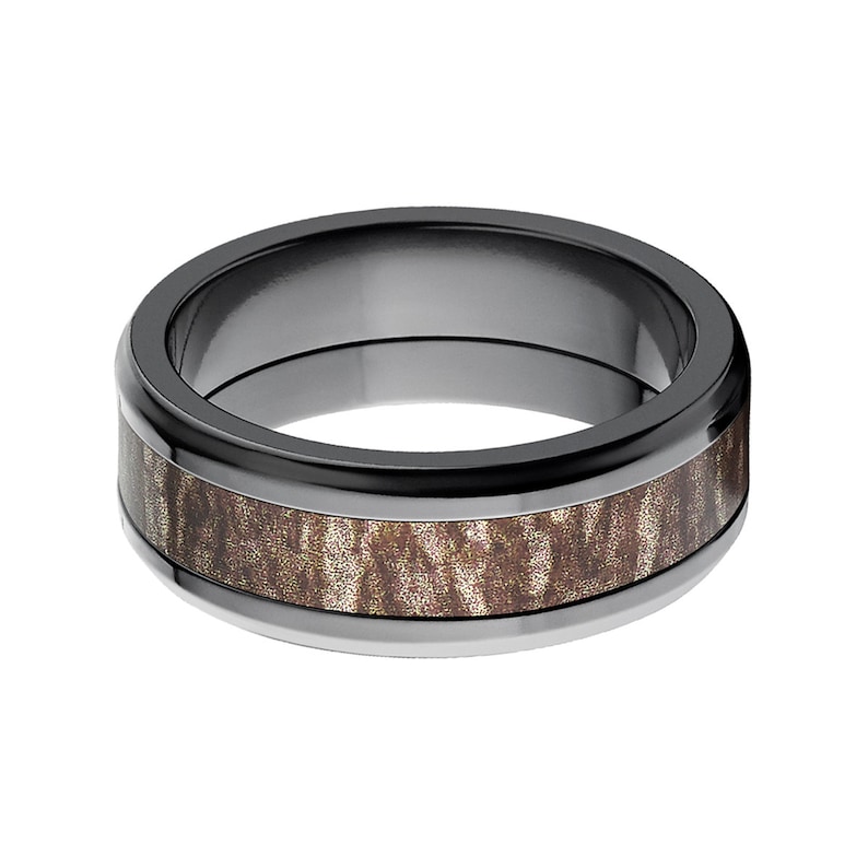 May include: A black ceramic ring with a brown wood inlay. The ring has a beveled edge and a polished finish.