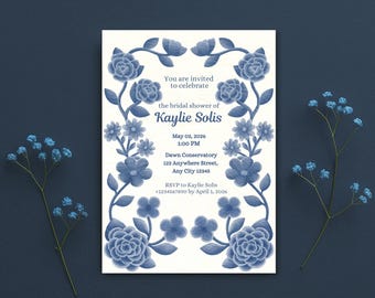 May include: A bridal shower invitation with a floral design in shades of blue. The invitation includes the text "You are invited to celebrate the bridal shower of Kaylie Solis" and event details. The invitation is surrounded by blue flowers.
