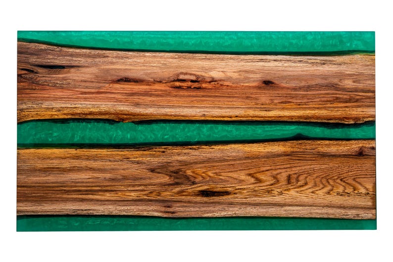 May include: A wooden serving board with three layers of wood and two layers of green epoxy resin.