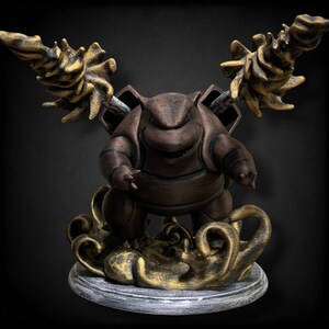 May include: A bronze-colored Pokemon figurine of a turtle-like creature with spikes on its back. The figurine is standing on a gold-colored base with a gray marble-like surface.