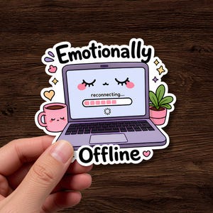 May include: A die-cut sticker featuring a light purple laptop with a sleepy face on the screen, displaying the text 'reconnecting...' and a loading bar. The sticker includes a pink mug, a small potted plant, and the text 'Emotionally Offline'.