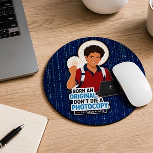 May include: A round mousepad featuring a dark blue background with a digital binary code pattern. It displays an illustration of a young person with curly hair, a red shirt, and a backpack, holding a white host, with the text BORN AN ORIGINAL. DON'T DIE A PHOTOCOPY. — ST. CARLO ACUTIS.