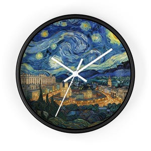 May include: Round wall clock with a black frame featuring a print of Van Gogh's "Starry Night" painting. The clock face displays a nighttime cityscape with swirling blue and yellow brushstrokes, and white clock hands.