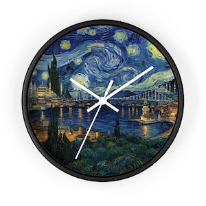 May include: Round wall clock with a black frame featuring a painting of a night scene with a bridge, buildings, and swirling blue sky. White clock hands indicate the time. The clock is a decorative item.