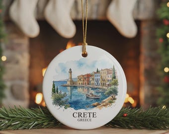 May include: A round white ceramic ornament featuring a watercolour illustration of a coastal harbour in Crete, Greece, with a lighthouse, colourful buildings, and boats on the water. The text CRETE GREECE is printed in black below the illustration.