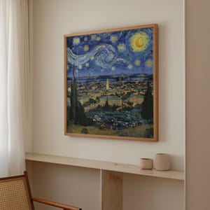 May include: A framed print of a cityscape at night, inspired by Van Gogh's "Starry Night." The artwork features a swirling blue night sky with stars and a crescent moon over a city with buildings and a bridge. The frame is made of light-colored wood.