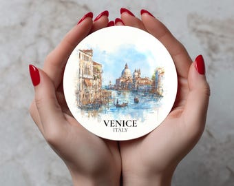May include: Round white coaster featuring a watercolor painting of Venice, Italy. The image depicts buildings, canals, and boats under a blue sky. The text "VENICE ITALY" is printed at the bottom.