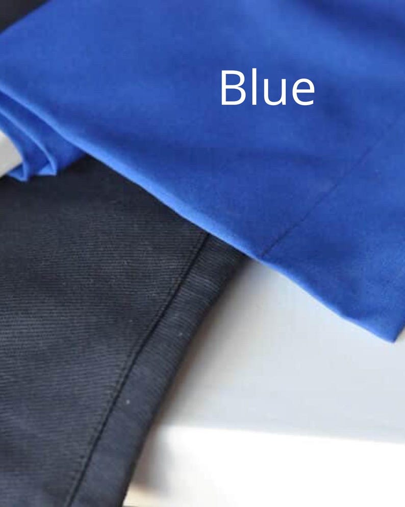 May include: Close-up of two pieces of fabric. One is a vibrant blue, with the word "Blue" in white text. The other is a dark navy blue. The fabrics appear to be smooth and possibly part of a garment.