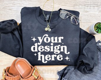 May include: Black sweatshirt with the text "your design here" in white. The sweatshirt has a gold chain necklace with a star charm.
