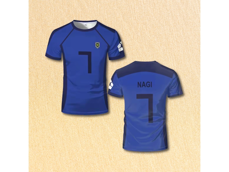 May include: Blue short-sleeved athletic jersey with the number 7 in black on the front and back. The back of the jersey also displays the name "NAGI". The jersey has a small emblem on the chest.