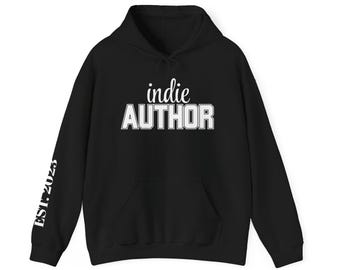 May include: Black hoodie with the words "indie AUTHOR" in white block letters across the chest. The left sleeve has "EST. 2023" printed vertically in white. Features a drawstring hood and a front pocket.