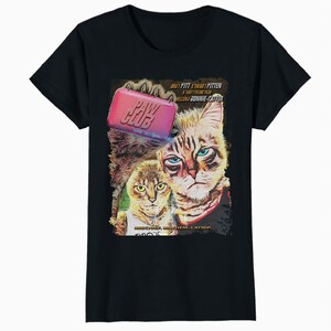 May include: Black t-shirt featuring a graphic of two cats with the text "PAW CLUB" and movie-style credits. The cats have blue and yellow eyes. The shirt is made of a soft, comfortable material.