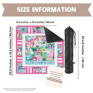 May include: A pink and blue picnic blanket with a Charleston design, measuring 33.0 x 31.5 inches (83.8 x 80.0 cm). The blanket features illustrations of colorful houses and palm trees, with the text "LET'S CHARLESTON". Includes a black carrying bag.