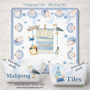 May include: A Mahjong Mat and Tile Bag Set featuring a beach theme. The mat has seashells, starfish, and a seagull illustration. The tile bag set includes two white pouches, one labeled "Mahjong" and the other "Tiles". The set is designed with a blue and white color scheme.