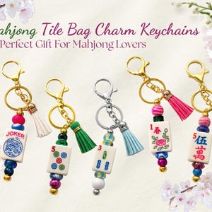 May include: Mahjong tile bag charm keychains with gold and silver-tone hardware. Each charm features a Mahjong tile, colorful beads, and a tassel. The charms have the text "JOKER", "5", "3", "1", and "伍萬".
