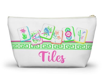 May include: White zippered pouch with a pink and green border design. The pouch features watercolor illustrations of tiles with floral and bird designs. The word "Tiles" is written in pink script across the front.