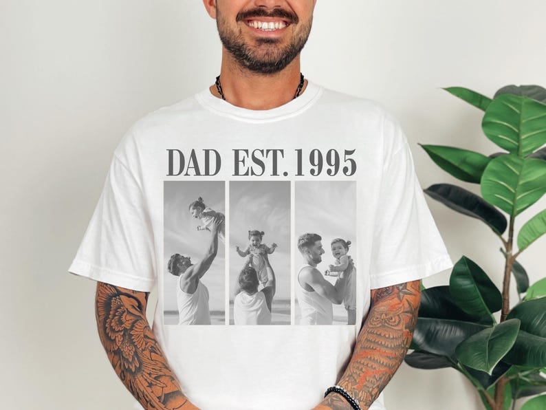 White unisex t-shirt with bold black text “DAD EST. 1995” above a black-and-white three-photo collage of a dad and daughter at the beach. Features joyful, candid fatherhood moments. Perfect personalized gift for Father’s Day, birthdays, or first-time dads. Soft, relaxed fit tee with a meaningful design—ideal for sentimental dads and custom photo apparel lovers.