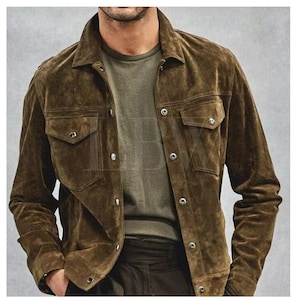 May include: A brown suede jacket with a button-up front and two large flap pockets. The jacket has a classic denim-inspired style.