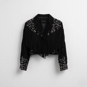 May include: Black cropped jacket with fringe and silver stud accents. The jacket features a classic collar, long sleeves, and decorative metal rings. The fringe detail is along the chest, back, and sleeves.