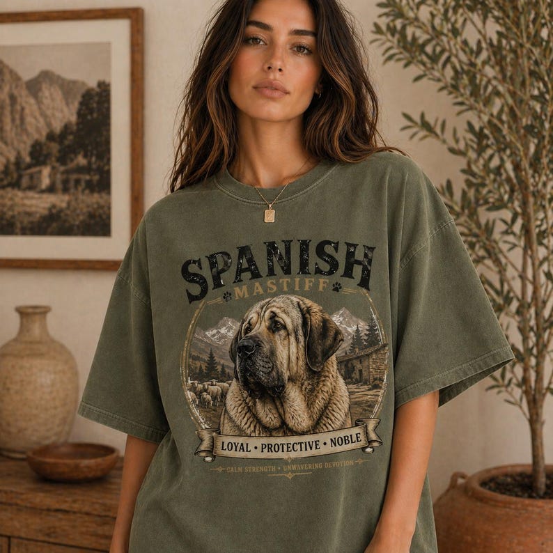 Spanish Mastiff shirt featuring a detailed vintage dog illustration printed on a premium Comfort Colors t-shirt. This oversized graphic tee showcases a loyal and protective mastiff design with rustic mountain and farm elements, perfect for dog lovers, breeders, and large dog owners. Styled in a cozy lifestyle mockup, this aesthetic dog breed shirt makes a unique gift for Spanish Mastiff fans and pet lovers.