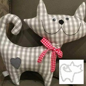 May include: A stuffed cat toy made of gray and white checkered fabric. The cat has a red and white checkered bow, a gray heart patch, and button eyes. A cat-shaped pattern is in the lower right corner.