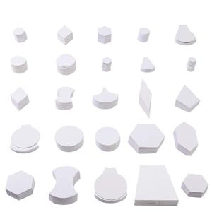 May include: A collection of white paper shapes, including circles, hexagons, and irregular forms, are arranged against a white backdrop. The shapes are stacked in varying heights, showcasing their three-dimensional forms.