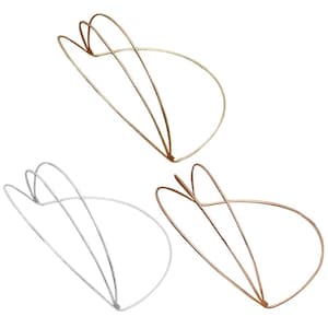 May include: Three wire taco holders in gold, silver, and rose gold tones. Each holder features a curved, open-frame design constructed from thin metal wire, forming a stable base and two upright supports to hold a taco shell in an upright position.