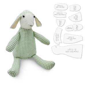 May include: A handmade stuffed lamb toy with a green and white checkered pattern. The lamb has a white face and ears, and black eyes. Accompanying the lamb are pattern pieces labeled with text including "54R10-10" and "Back body #04x2".