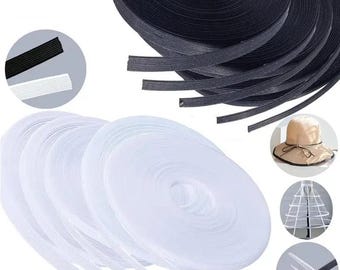 May include: Spools of black and white mesh ribbon are displayed. The black ribbon is in a large roll, while the white ribbon is in several smaller rolls. Additional images show a hat, a petticoat, and close-ups of the ribbon.